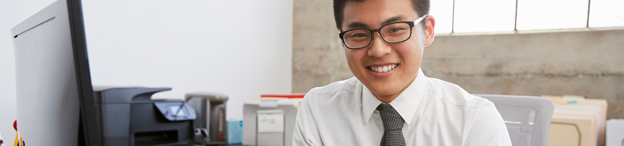 businessman sitting behind desk